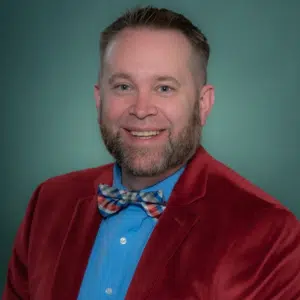 Aragon Professional headshot with dark teal background copy for Recruitment Consulting by Talento