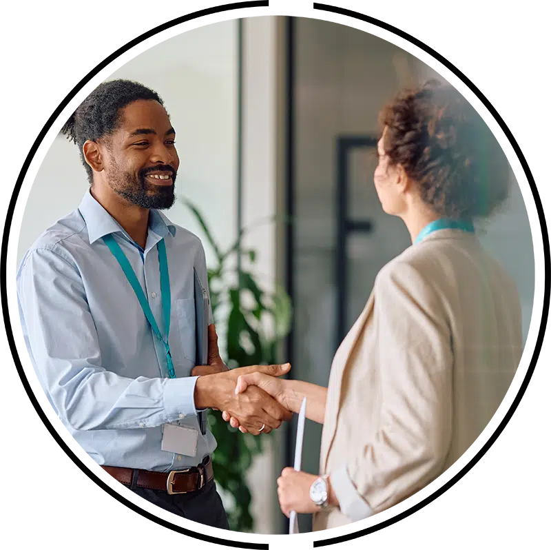 Man and woman shaking hands after a meeting in our Dallas field office